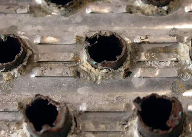 Coil surface without Blygold protection showing visible corrosion.